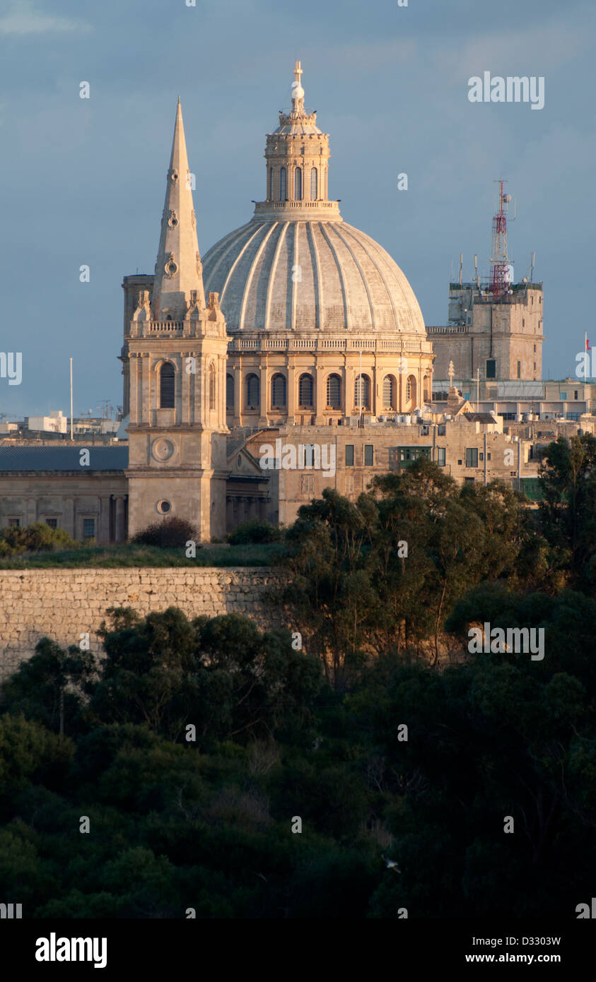 Valletta, St. John`s Co Cathedral, evening sun, trees in foreground, blue/grey sky, wintry Stock Photo